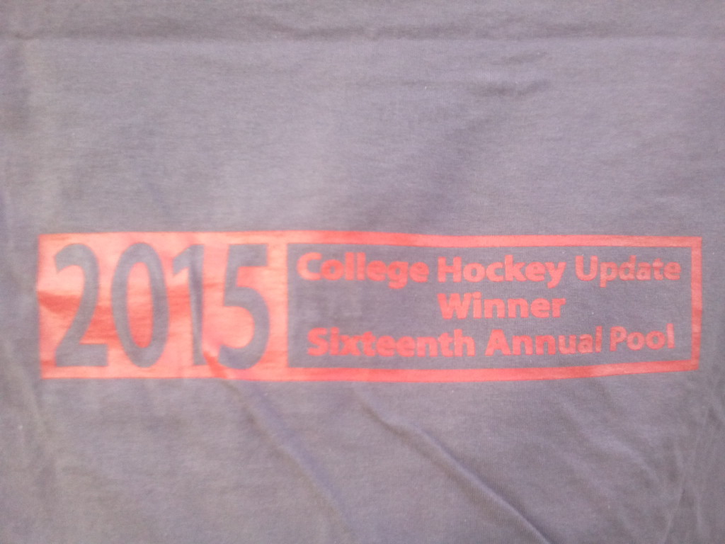 The custom-made College Hockey Update logo on the back panel of the 2015 Trophy T-Shirt, won by Ken Klein.