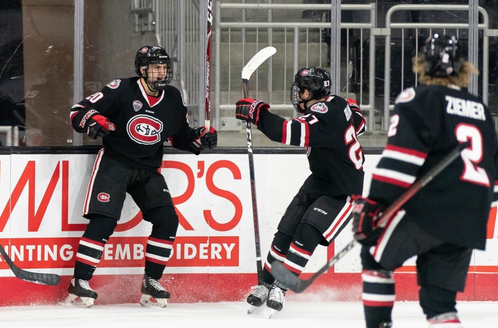 St. Cloud State junior forward Nolan Walker (#20 at left), of Anchorage, AK., and his teammates, are jubilant after he scored the important third goal, helping his team to a 4-1 win over Boston College in second round action of the NCAA Tournament yesterday in Bridgeport, CT.  St. Cloud State, now 19-10-0, and ranked #7, advanced to the Frozen Four in Pittsburgh, where they will face #5 Mankato State in a semifinal game on Thursday, April 8th, at 2:00pm Pacific Time on ESPN2.