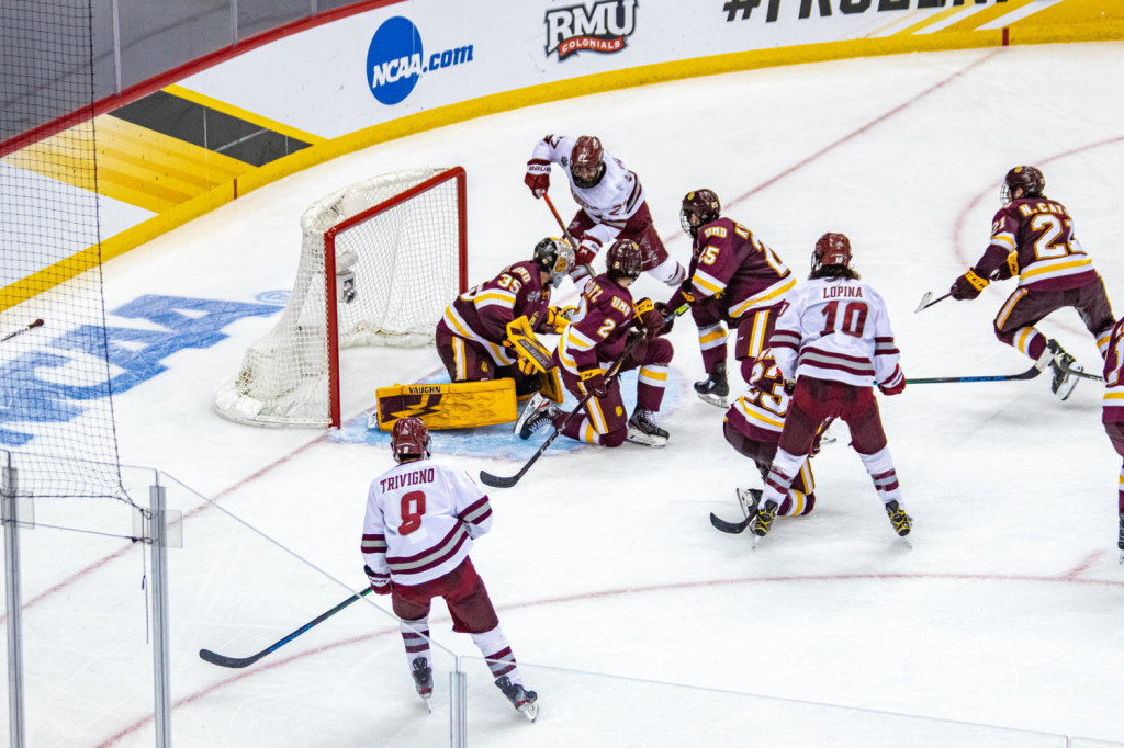 Massachusetts junior forward Anthony Del Gaizo, of Basking Ridge, N.J. (center, at top in white jersey), scored this critical game-tying goal that seemed as though it would never come, in the third period yesterday, to force overtime, helping his team to its 3-2 OT win over #9 Minnesota-Duluth yesterday.  Massachusetts, 19-5-4, and ranked #6, will face #7 St. Cloud State tomorrow in the Frozen Four Championship Game in Pittsburgh, PA., at 4:00pm Pacific Time on ESPN.