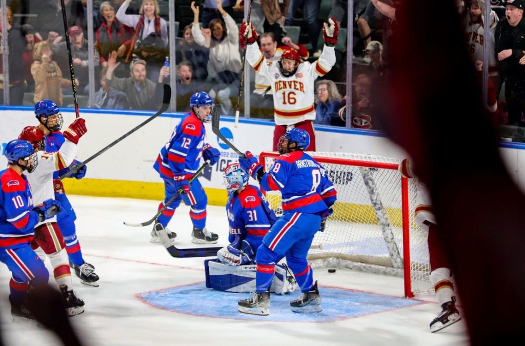 Denver senior forward Cameron Wright, of Newmarket, ONT. (#16 in white), jumped for joy after scoring his late game-winning goal to help his team beat UMass-Lowell in the late opening round game of the Western Region in Loveland, CO., on Thursday.  Wright is second on his  team in goals scored, with twenty-one, and is thirteenth in assists, with ten.  Denver advanced to play Minnesota-Duluth n the Western Region Championship game in Loveland, CO., on Saturday.